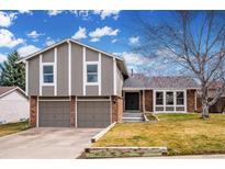Charming two-story home featuring a two-car garage, brick accents, and beautifully landscaped front yard at 7308 S Zephyr Way, Littleton, CO 80128