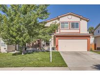 Charming two-story home featuring a well-manicured lawn, two-car garage, and inviting curb appeal at 6367 Xavier St, Arvada, CO 80003