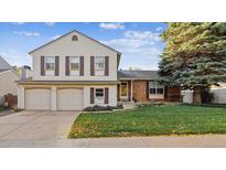 Charming two-story home featuring a well-maintained front lawn and an attached two-car garage at 4702 E Costilla Ave, Centennial, CO 80122
