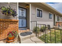 Charming front door with flower basket and brick accents, creating a welcoming entrance to the home at 4028 Ames St, Wheat Ridge, CO 80212