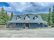 Charming two-story home with a covered porch nestled among mature trees at 234 Carroll Ln, Breckenridge, CO 80424