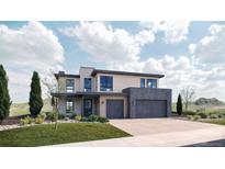 Modern two-story home with a three-car garage and well-manicured lawn, showcasing sleek architectural design at 5326 Lions Paw St, Castle Rock, CO 80104
