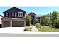 Beautiful two story home showcasing a well-manicured yard and attached two car garage at 7408 Sodalite Way, Castle Rock, CO 80108