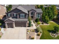 Beautiful brown two-story home with a landscaped front yard and a two-car garage at 7408 Sodalite Way, Castle Rock, CO 80108