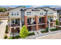 Beautiful townhome with brick accents and private balconies on a sunny day at 7808 W 43Rd Pl, Wheat Ridge, CO 80033