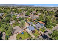 A lovely neighborhood with mature trees and mountain views in the distance at 4635 Teller St, Wheat Ridge, CO 80033