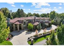 Stunning aerial view of estate with sprawling driveway and lush landscaping under a blue sky at 2 Viking Dr, Englewood, CO 80113