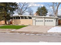 Ranch style home with attached two-car garage and landscaped lawn at 3097 E Caley Ave, Centennial, CO 80121