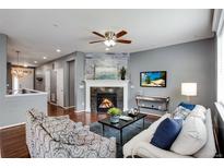 Inviting living room features a cozy fireplace, modern decor, and comfortable seating arrangement at 602 Mathews Way, Erie, CO 80516