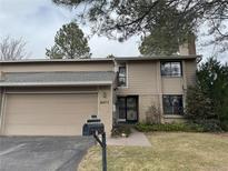 Charming two-story townhome with attached garage and well-maintained landscaping at 6475 S Arapahoe Way, Littleton, CO 80120