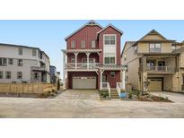 Eye-catching three-story home featuring a charming front porch and a convenient two-car garage at 7293 Waterleaf Trl, Littleton, CO 80125