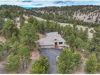 Beautiful home nestled in a wooded area with a large driveway and a charming tiled roof at 2122 Montane Dr, Golden, CO 80401
