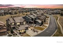 Beautiful two-story home boasts a well-manicured front yard and tasteful landscaping and a large driveway at 10610 Greycliffe Dr, Highlands Ranch, CO 80126