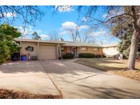 Charming single-story brick home with a well-maintained lawn and attached garage at 3311 S Dahlia St, Denver, CO 80222