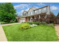 Beautiful two-story home featuring a well-manicured lawn and brick accents at 5774 S Genoa Ct, Aurora, CO 80015