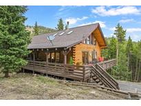 Charming log cabin with a large deck, perfect for enjoying the serene mountain views at 1673 Sinton Rd, Evergreen, CO 80439