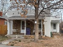 Charming stucco home with a covered porch and mature tree at 4116 Bryant St, Denver, CO 80211