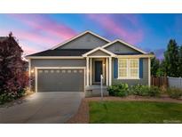 Charming single-Gathering home featuring a well-maintained lawn, attached garage and inviting entrance at 2043 S Cathay Way, Aurora, CO 80013