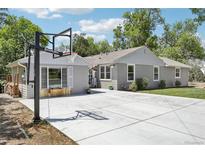 Charming gray home featuring a basketball hoop and a spacious concrete driveway perfect for outdoor activities at 9630 W 38Th Ave, Wheat Ridge, CO 80033