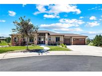 Beautiful single-story home featuring stone accents, a landscaped yard, and a two-car garage on a sunny day at 372 Castlemaine Ct, Castle Rock, CO 80104
