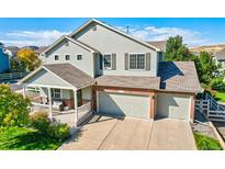 Charming two-story home features a welcoming front porch and attached two-car garage at 3779 Aspen Hollow Ct, Castle Rock, CO 80104