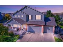 Charming two-story home with a welcoming front porch and a three-car garage at 3779 Aspen Hollow Ct, Castle Rock, CO 80104