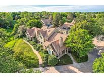 A beautiful exterior shot showcasing a well-maintained home surrounded by lush green trees at 2299 Ranch Dr, Westminster, CO 80234