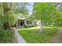 Charming single-story home with a well-maintained lawn and mature trees, offering great curb appeal at 5355 S Windermere St, Littleton, CO 80120