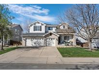 Spacious home with a three-car garage and well-maintained lawn, providing ample parking and curb appeal at 9877 Arthur Ln, Highlands Ranch, CO 80130