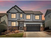 Charming two-story home featuring white siding, dark trim, and an attached two-car garage at 2853 Black Canyon Way, Castle Rock, CO 80109