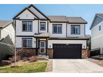 Charming two-story home with black trim, updated windows, brick accents, and a two-car garage at 2853 Black Canyon Way, Castle Rock, CO 80109