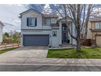Charming two-story home featuring blue shutters, a well-kept lawn, and an attached two-car garage at 294 Willowick Cir, Highlands Ranch, CO 80129
