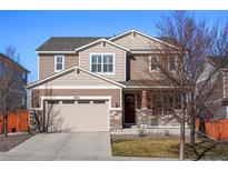 Charming two-story home with a two-car garage and welcoming front porch at 10055 Fort Worth Ct, Parker, CO 80134