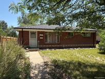 Charming brick home featuring a well-maintained lawn and inviting front entrance at 3054 Victor St, Aurora, CO 80011