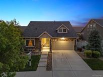 Charming single-Gathering home featuring manicured landscaping and inviting front porch at 5471 Ensenada Ct, Denver, CO 80249