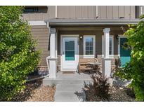 Charming front porch with cozy bench seating, perfect for enjoying a morning coffee at 14700 E 104Th Ave # 1105, Commerce City, CO 80022