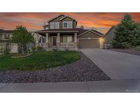 Charming two-story home boasting a covered front porch, well-manicured lawn, and an attached two-car garage at 3790 Aspen Hollow Ct, Castle Rock, CO 80104