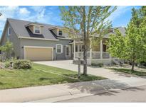 Charming two-story home with a spacious driveway, a two car garage, and a welcoming covered front porch at 3342 Springmeadow Cir, Castle Rock, CO 80109
