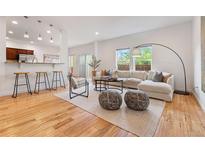 Bright, open-concept living room with hardwood floors and modern furnishings at 4190 W Alameda Ave, Denver, CO 80219
