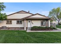 Charming home with a well-maintained lawn, complemented by neat landscaping and a welcoming entrance at 8767 Chase Dr # 195, Arvada, CO 80003