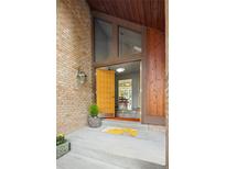 Inviting front entrance features a striking brick facade and unique architectural details at 10572 E Orchard Pl, Englewood, CO 80111