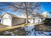 Gray exterior home with attached garage and small front yard at 14393 E Marina Dr, Aurora, CO 80014