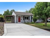Charming single-story home featuring a red door, covered parking, and a well-maintained front yard at 2735 S Dahlia St, Denver, CO 80222