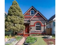 Charming single-Gathering home featuring a red door and decorative brickwork under a sunny sky at 233 W 3Rd Ave, Denver, CO 80223