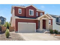 Charming two-story home with a two-car garage and stone-accented entryway in a residential neighborhood at 4840 Point Mesa St, Castle Rock, CO 80108