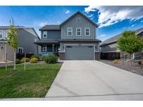 Charming two-story home features a covered front porch and attached two-car garage at 26985 E Bayaud Ave, Aurora, CO 80018