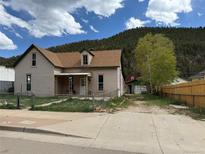 Charming home with a quaint front porch and view of the mountains in the background at 219 Colorado Blvd, Idaho Springs, CO 80452