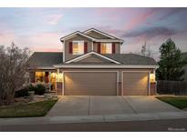 Charming two-story home featuring a three-car garage and well-maintained landscaping at 1271 Berganot Trl, Castle Pines, CO 80108
