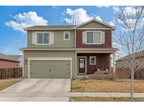 Inviting two-story home featuring a welcoming front porch with a swing and a convenient two-car garage at 7232 Shavano Ave, Frederick, CO 80504