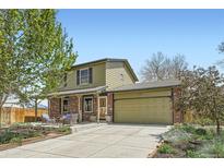 Charming two-story home featuring a brick-accented facade, a spacious front yard, and an attached two car garage at 10457 Owens Cir, Broomfield, CO 80021